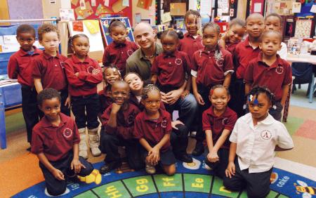 Longines Ambassador of Elegance Andre Agassi with a group of children.