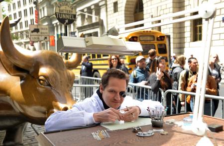 A watchmaker on his workbenche in the midst of New York City. 