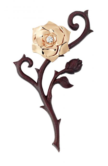 The Piaget trophy is a rose in pink gold. Here, she is clipped into a stylised stem handmade by a Swiss sculptor from amaranth wood.