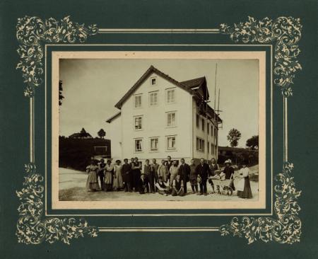 Georges-Édouard Piaget with family members and workers in front of the factory established in the former Café Français, 1911. ©Private funds